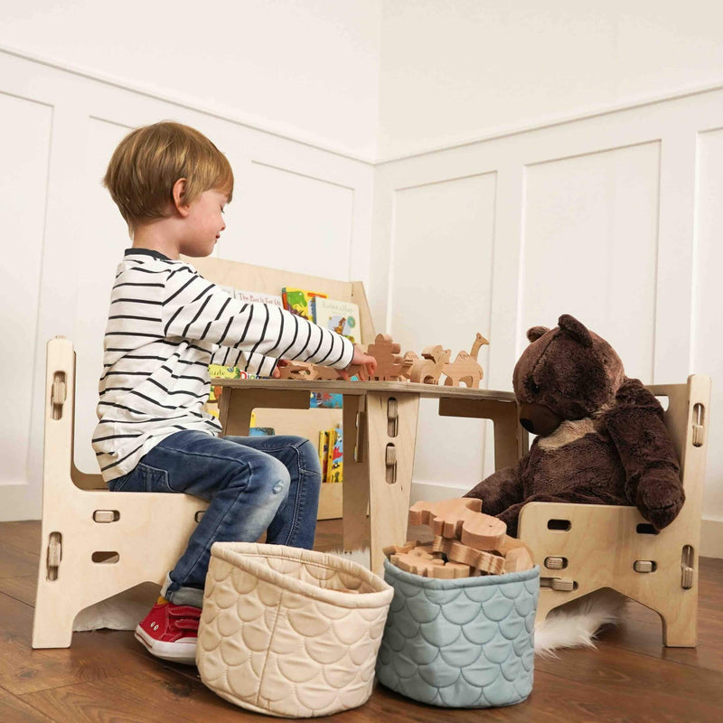 boy playing with his wooden animals on the eco double tea party set