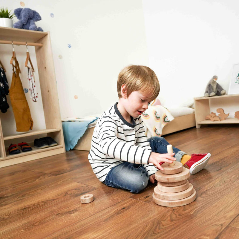 boy playing with the little stacker in the nursery collection room set