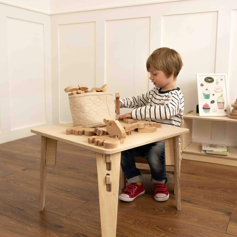 boyplaying with wooden farm animal collection