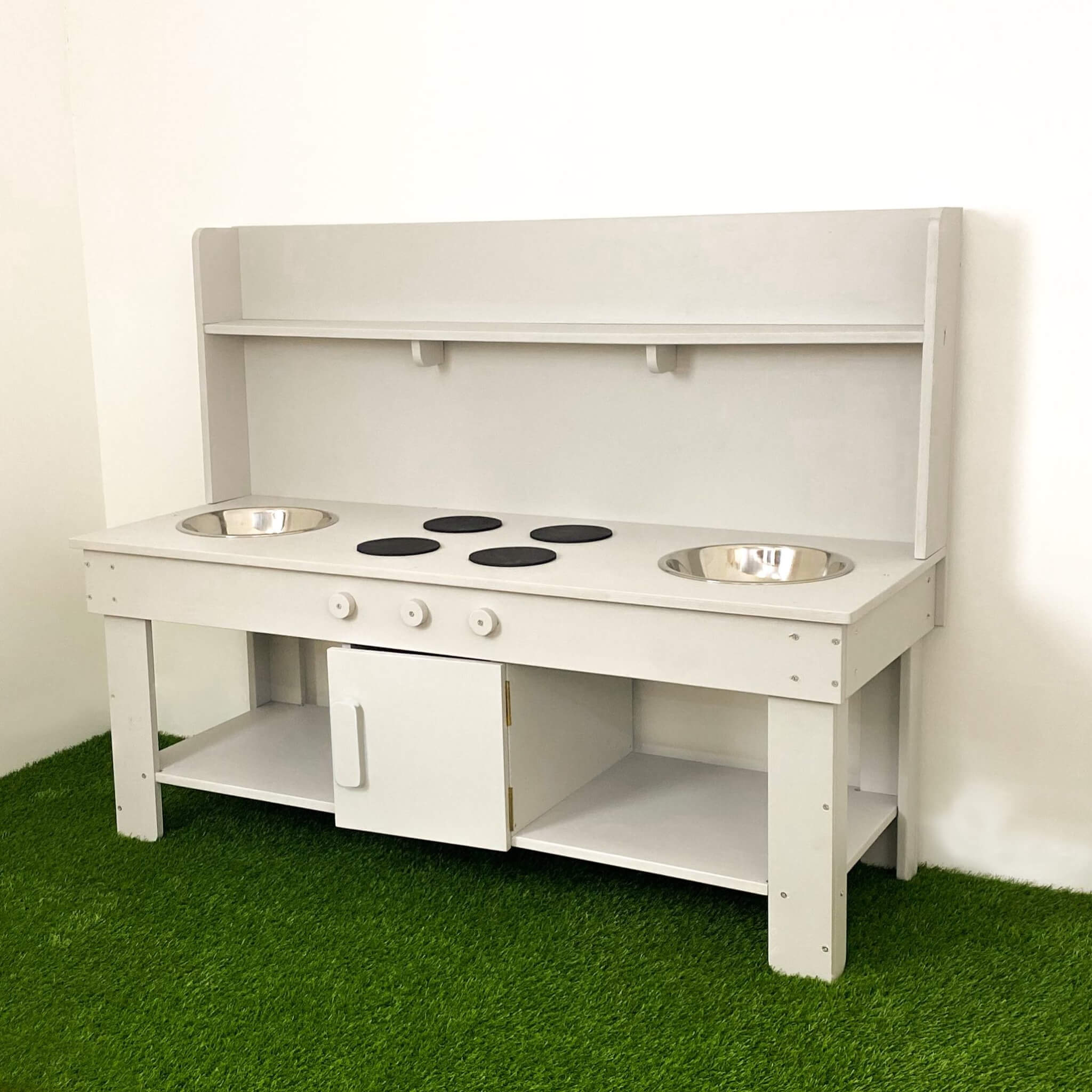 grey double mud kitchen with grass