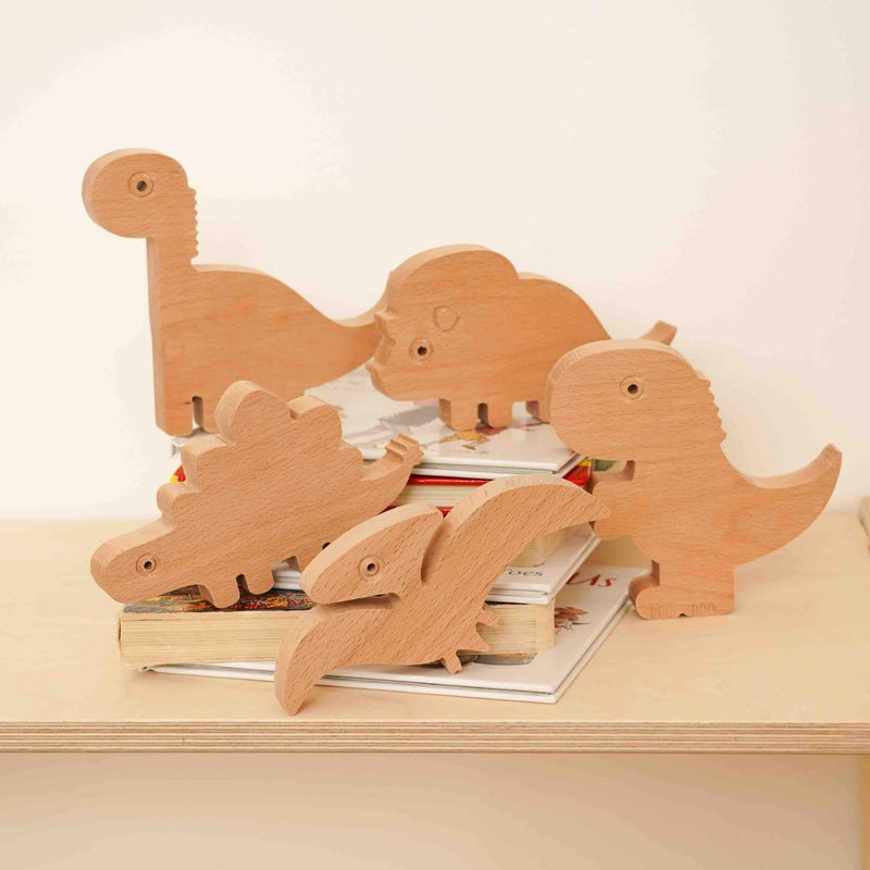wooden dino animals collection on books