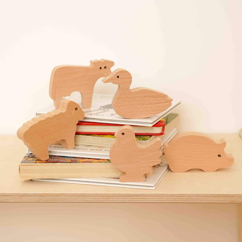 wooden farm animals collection on books